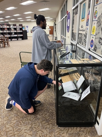 MGA history department representatives arranging their 483rd Bombardment Group archival collection in the Macon Campus Library.